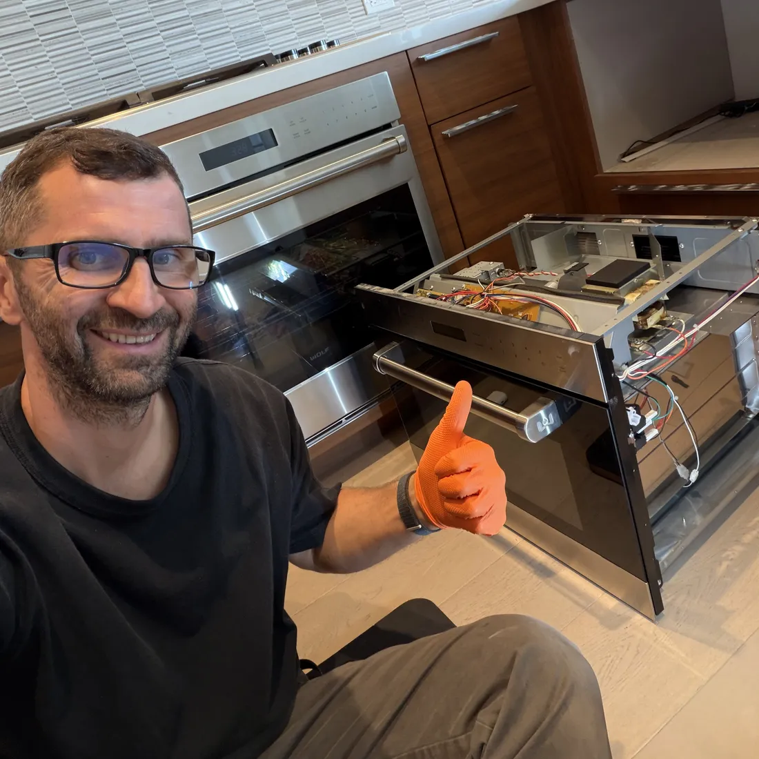 Technician repairing a built-in microwave in San Diego