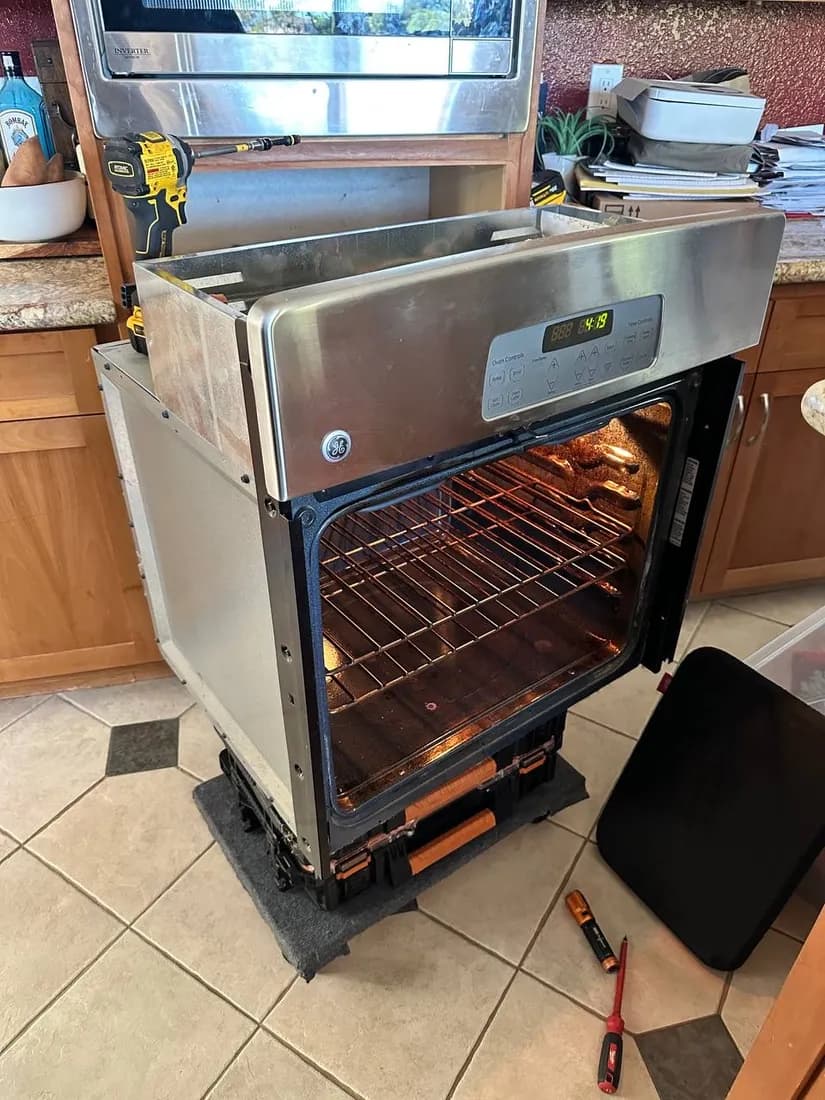 Built-in wall oven pulled out for service in San Diego