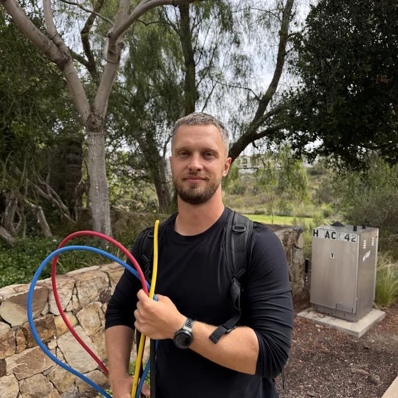 Andrew, appliance repair technician, with refrigerant gauges on a San Diego service call