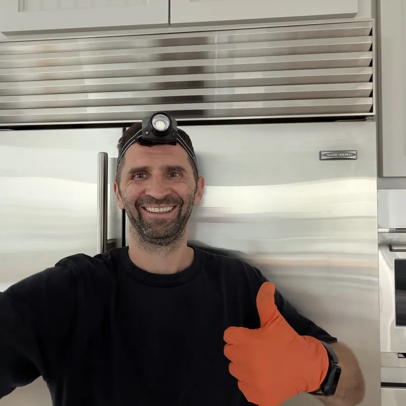 Yurii, appliance repair technician, at a Sub-Zero refrigerator on a San Diego service call